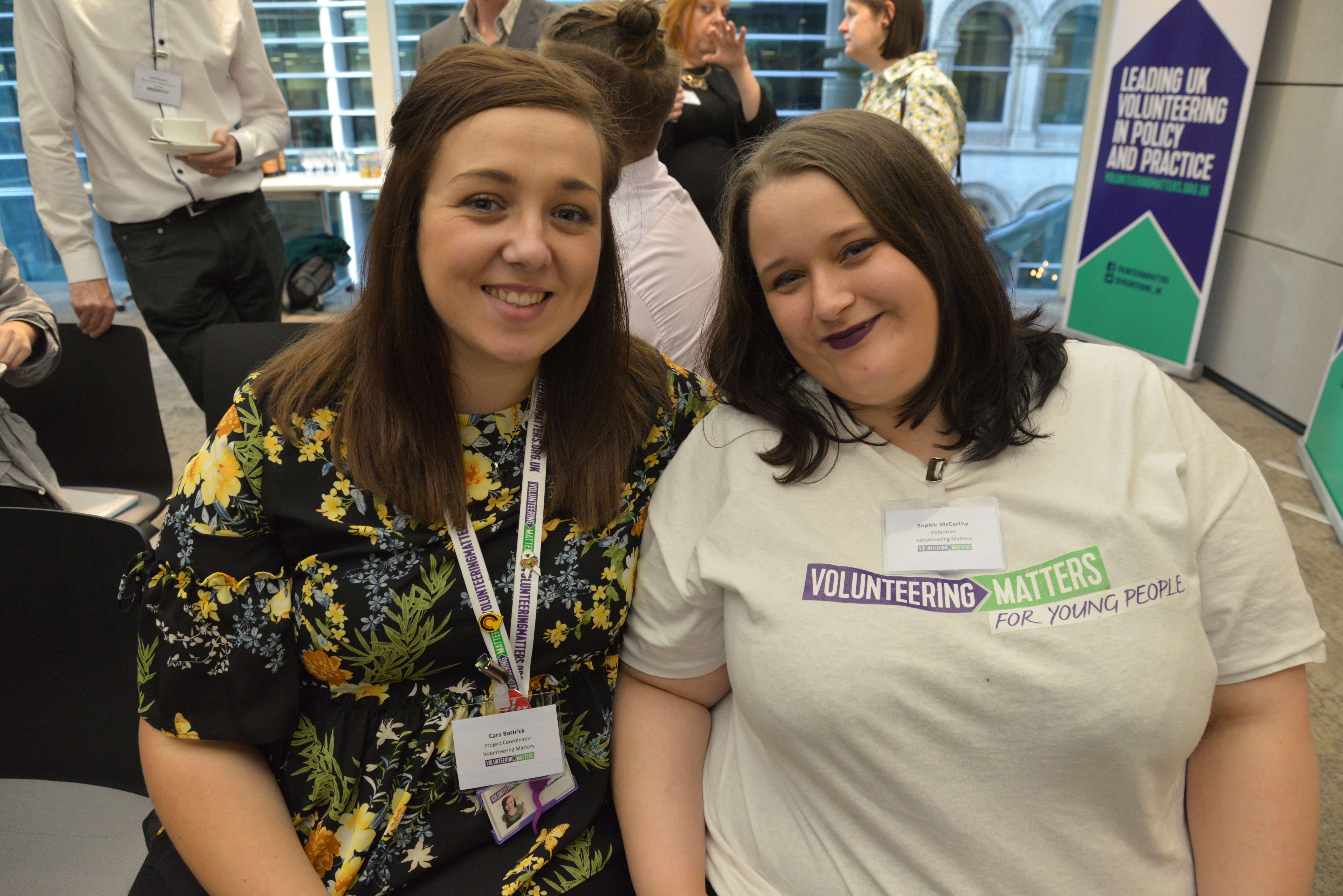 Two people looking at the camera, one has a Volunteering Matters tshirt on