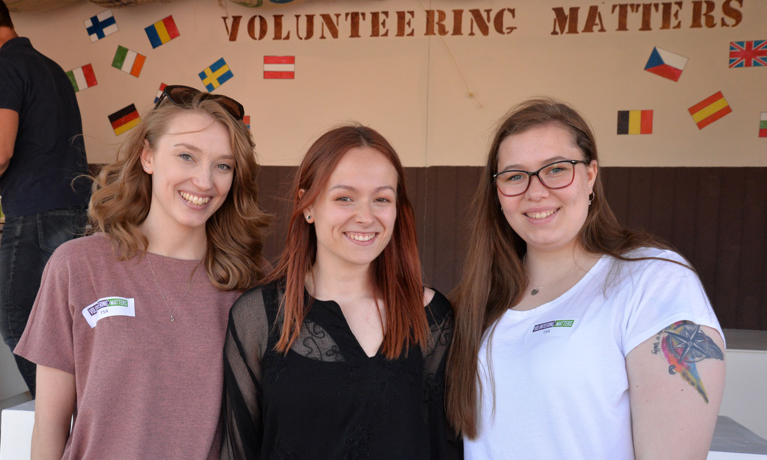 Three people stood looking at the camera