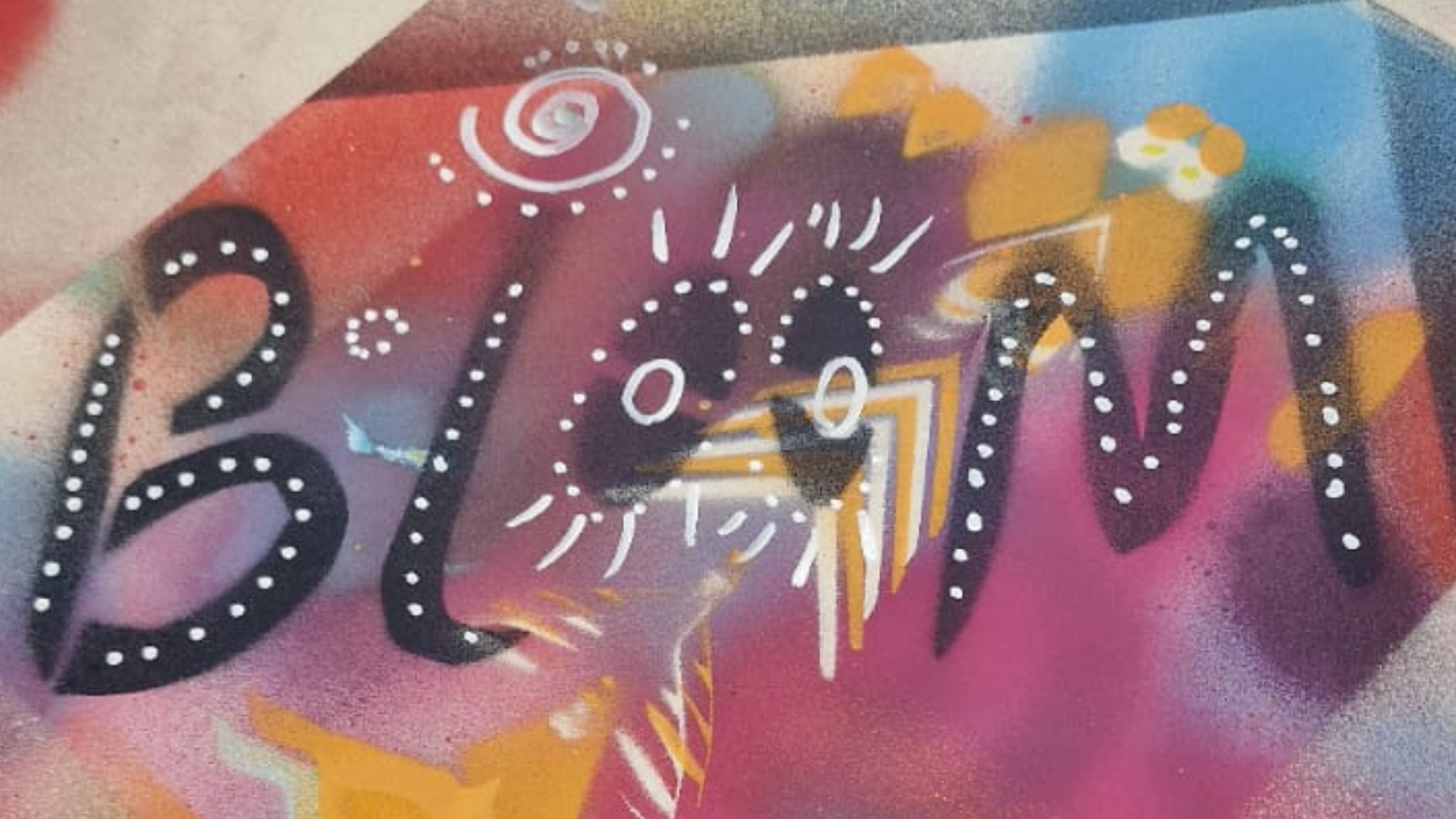 The word Bloom spray painted on a board