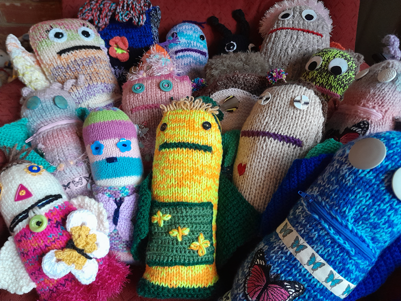 A selection of colourful knitted monsters