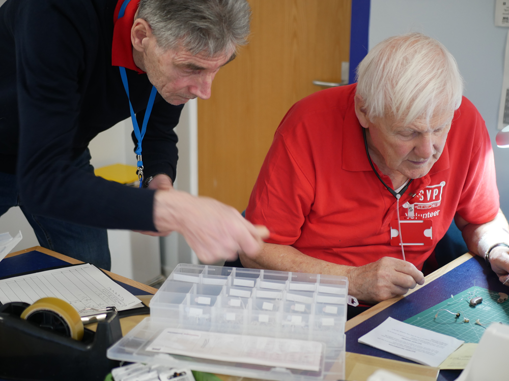 Two volunteers supporting one another
