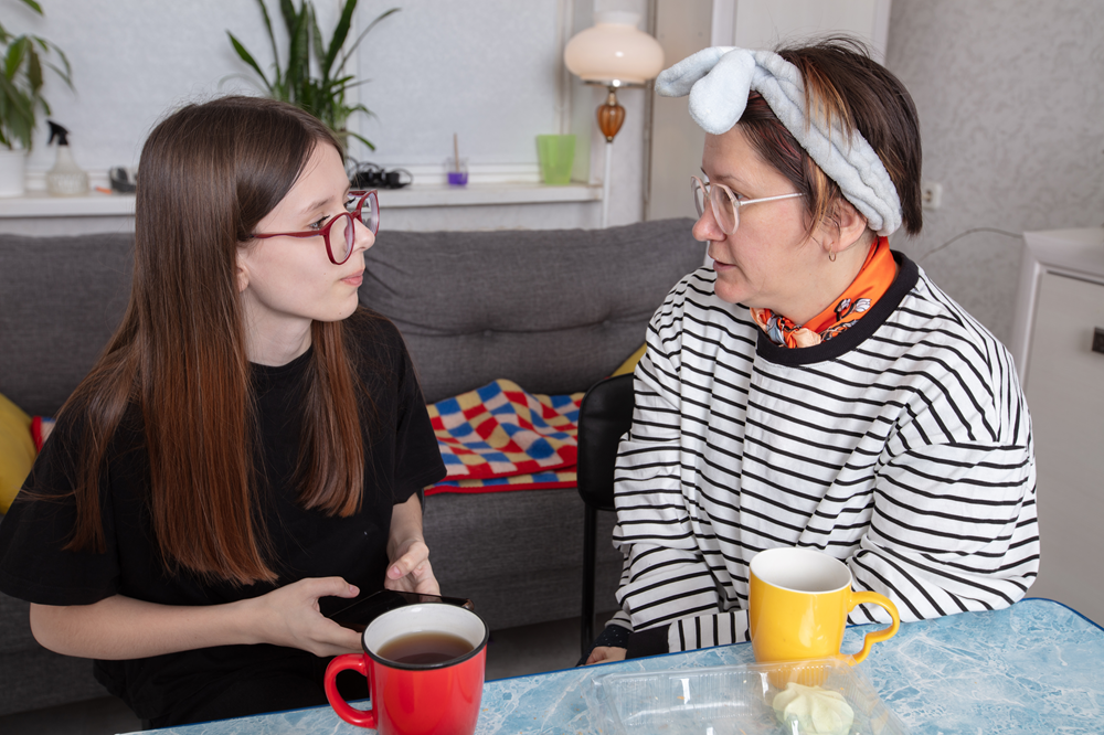 Two people sat at a table speaking