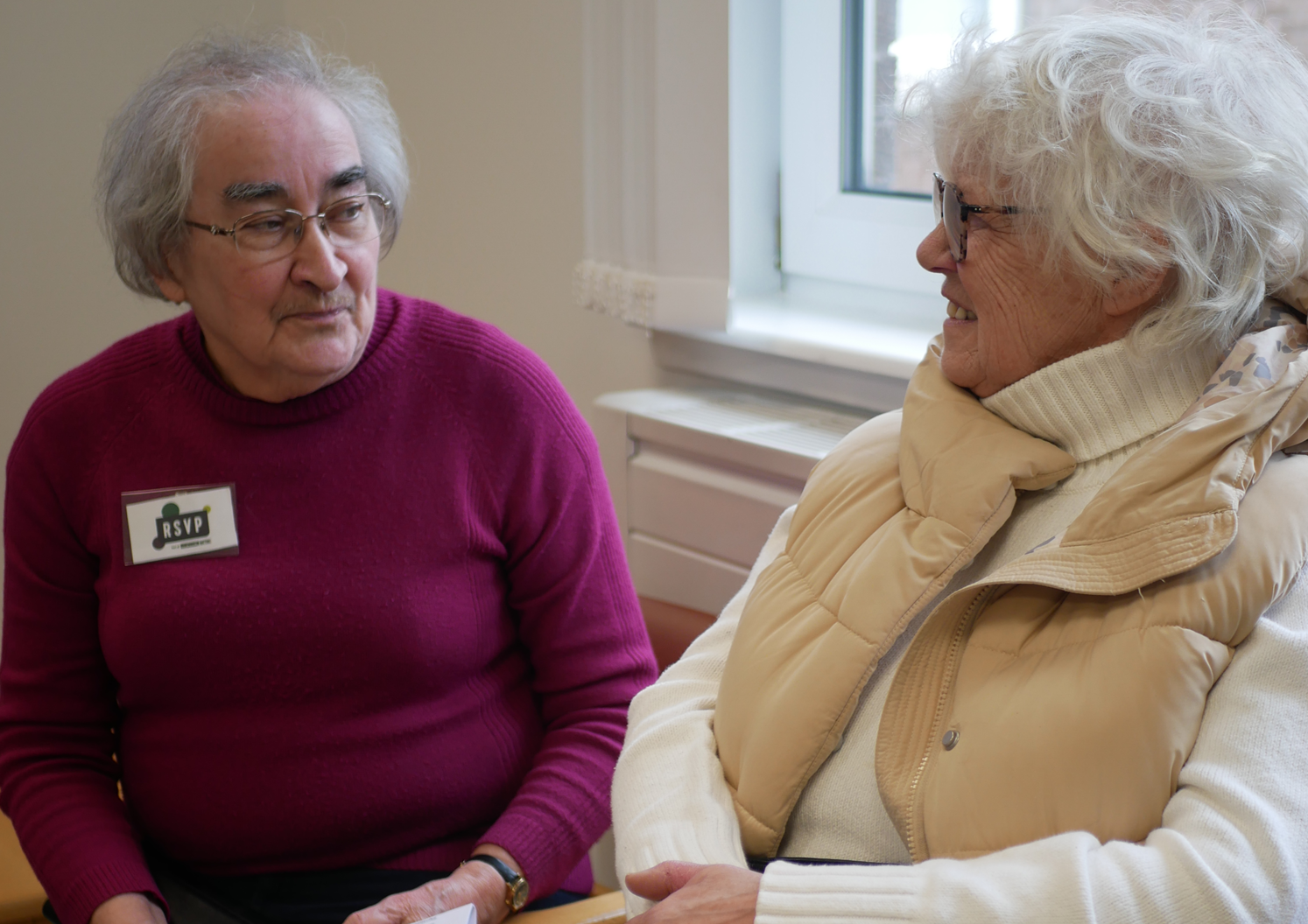 A person saying hello and speaking to someone else